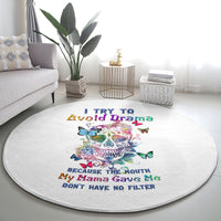 Round white rug with colorful sugar skull artwork, butterflies, and quote text in center
