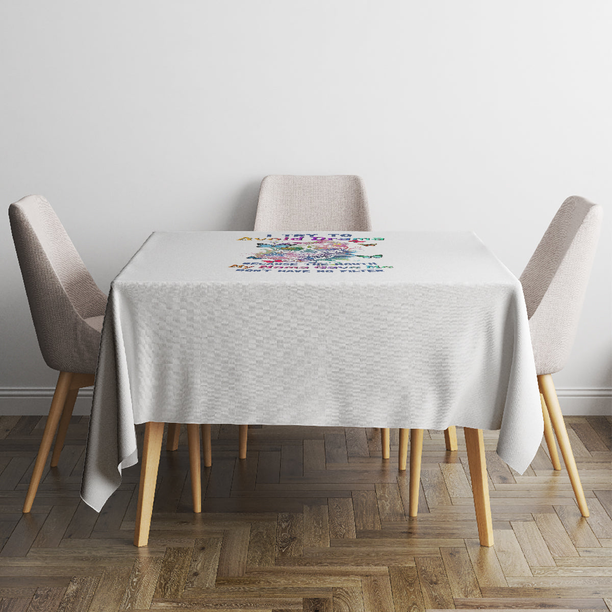White tablecloth neatly draped on square dining table with small multicolor text graphic