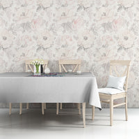 Grey tablecloth on dining table with multicolor printed motif across the top