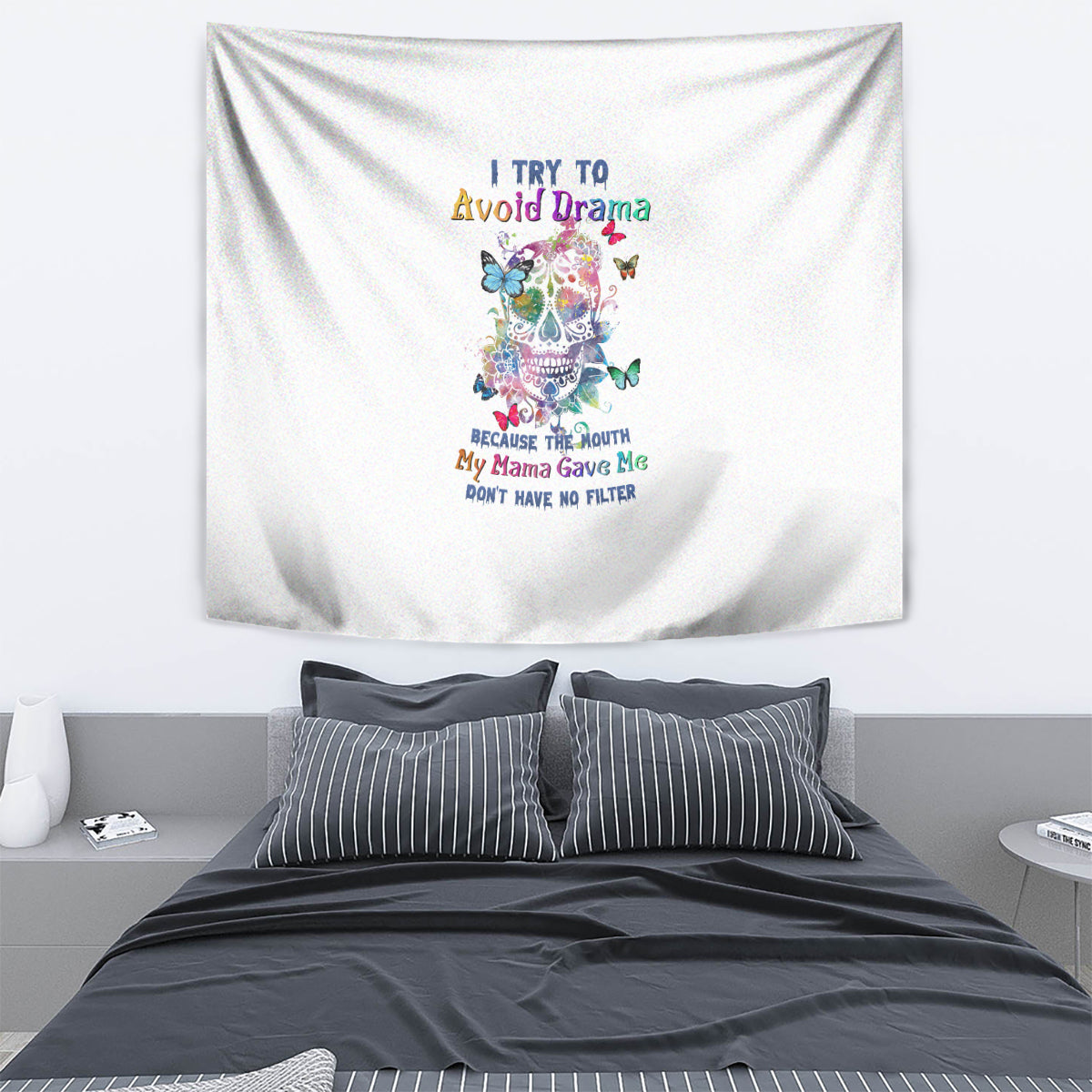 White tapestry wall hanging with colorful sugar skull and butterfly graphic, centered text