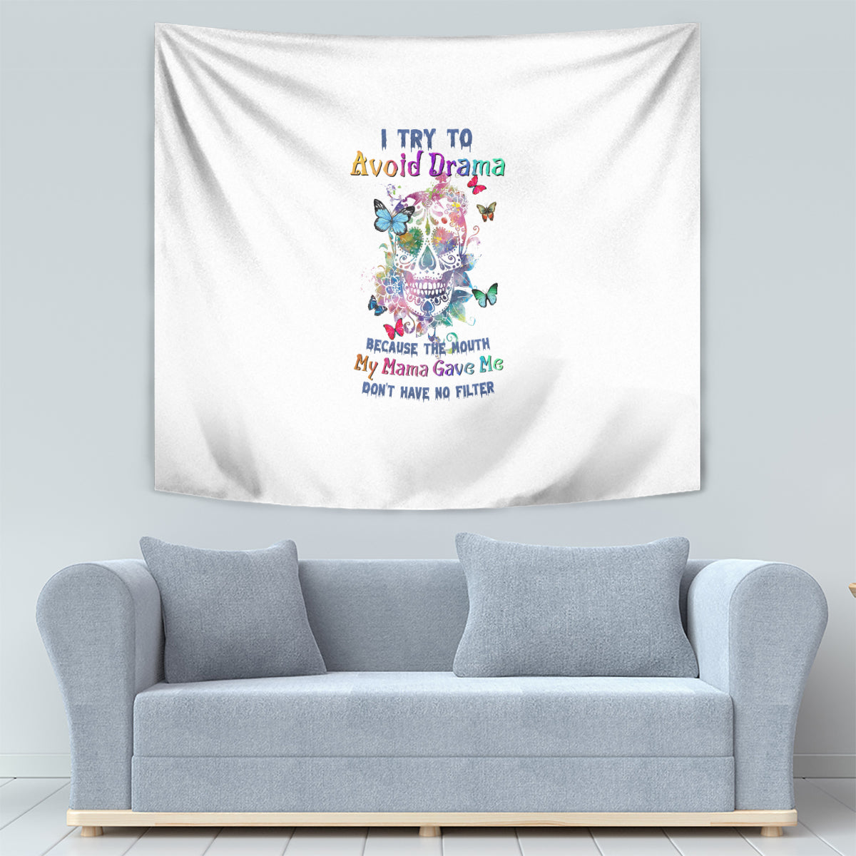 White tapestry wall hanging with colorful sugar skull illustration, butterflies, and multi-line text