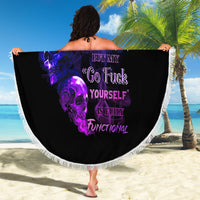 Round beach blanket held up: black skull graphic with purple and blue text, white fringe