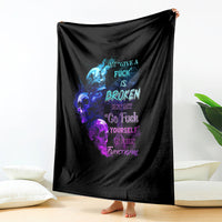 Black graphic throw blanket with blue and purple skull flame design, hanging upright