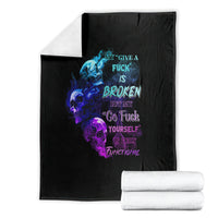 Black graphic throw blanket with blue and purple skull flame design, folded with white rolls