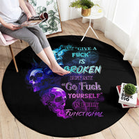 Black round carpet with blue-purple skull graphic and bold slogan typography