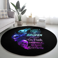 Black round carpet with blue flame skulls and pink slogan text, centered view