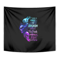 Black tapestry close-up with multicolor skull, flames, and centered word art.