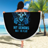 Round beach blanket held outdoors: black fabric with blue skull graphic and white fringe.