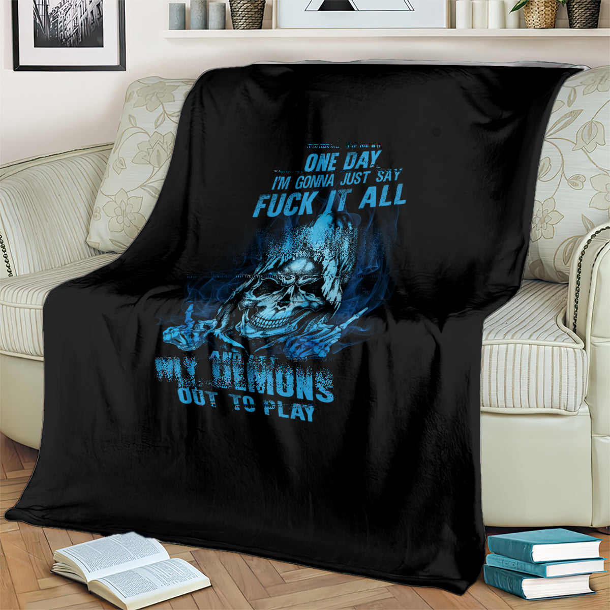 Black throw blanket featuring blue skull artwork and stacked text design