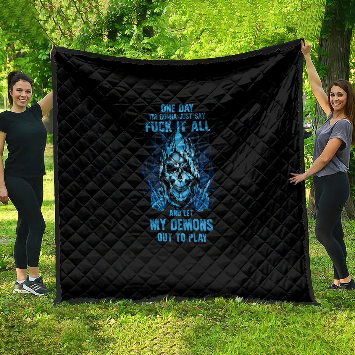 Black quilt with blue skull graphic and quilted diamond stitching