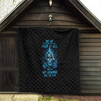 Black quilt with blue skull graphic, quilted diamond pattern displayed outdoors