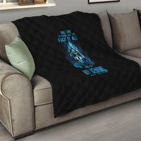 Black quilt with blue skull motif on a living-room sofa, diamond quilting