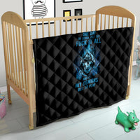 Black quilt with blue skull print draped on a child bed, diamond quilting