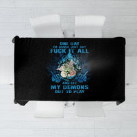 Black tablecloth with centered skull graphic and blue text, laid flat