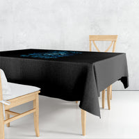 Black skull tablecloth with blue graphic, draped over a square table