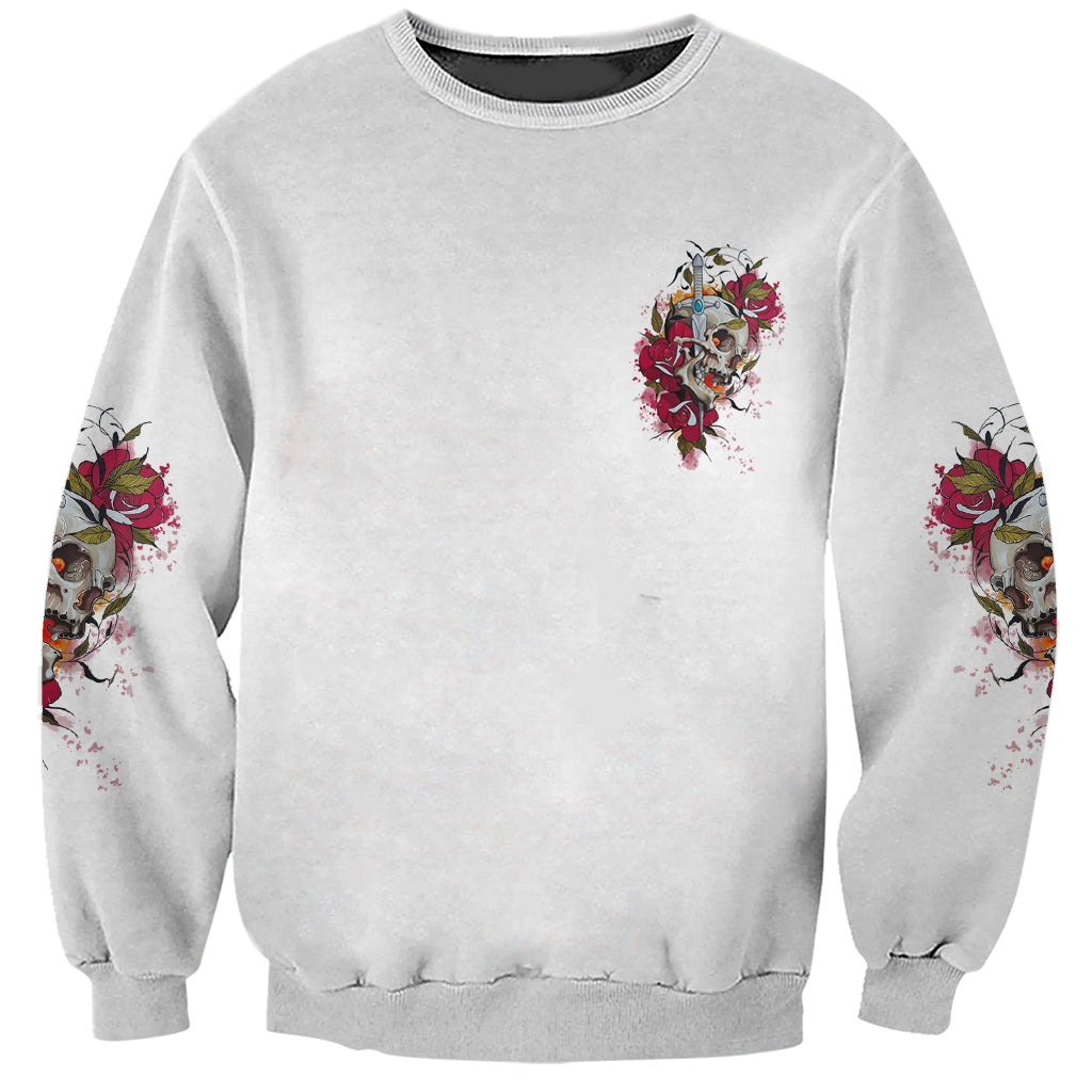Light gray sweatshirt with small front skull-and-rose graphic and rose skull prints on sleeves