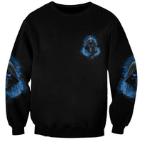 Black sweatshirt with small blue face emblem and blue artwork on sleeves