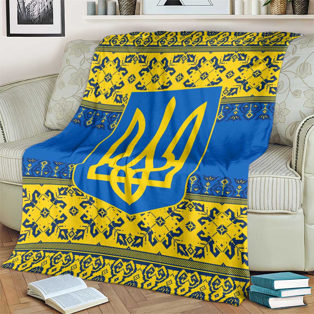 Blue and yellow trident emblem throw blanket with decorative borders, draped on couch