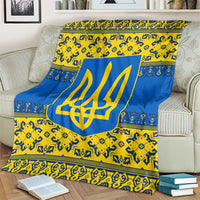 Blue and yellow trident emblem throw blanket with decorative borders, draped on couch