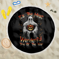 Round Halloween beach blanket, black with ghost and jack-o'-lantern motif, white fringe edge