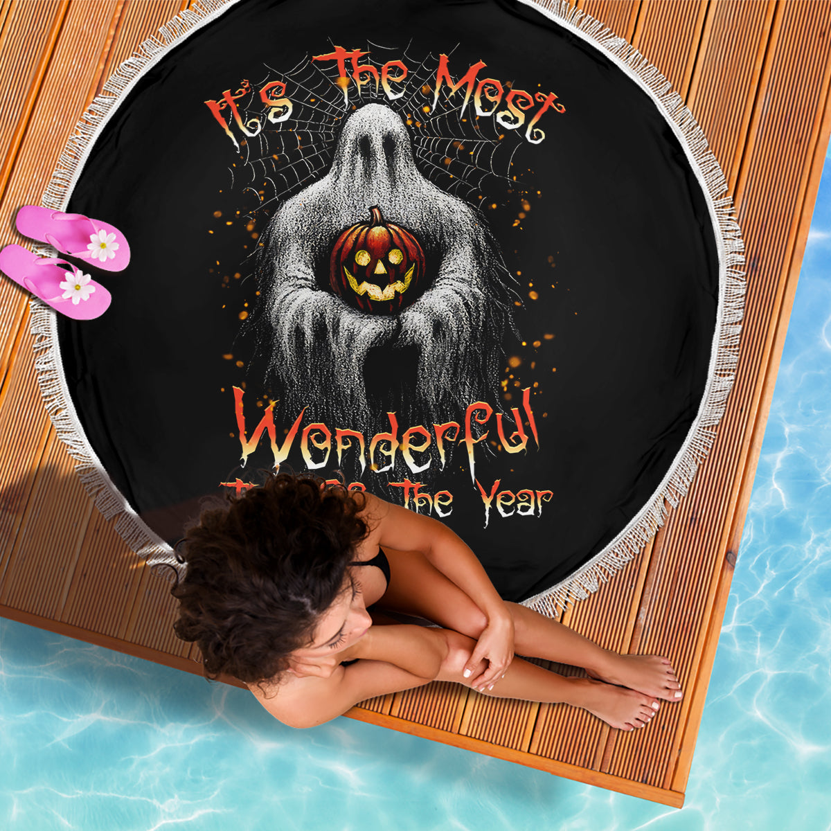 Round Halloween beach blanket, black with ghost holding jack-o'-lantern, white fringe