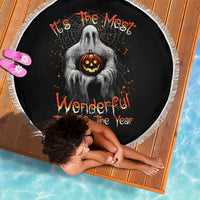 Round Halloween beach blanket, black with ghost holding jack-o'-lantern, white fringe