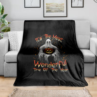 Black Halloween blanket with ghost holding jack-o-lantern and orange festive lettering