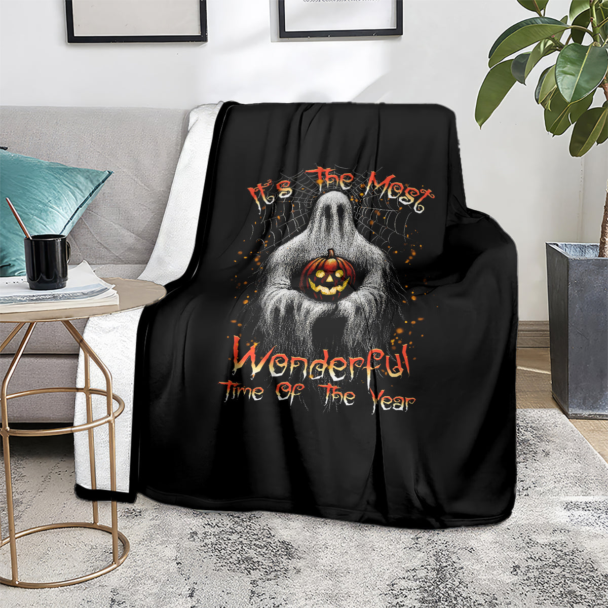 Black Halloween throw blanket with ghost holding jack-o-lantern and orange 'Wonderful' text