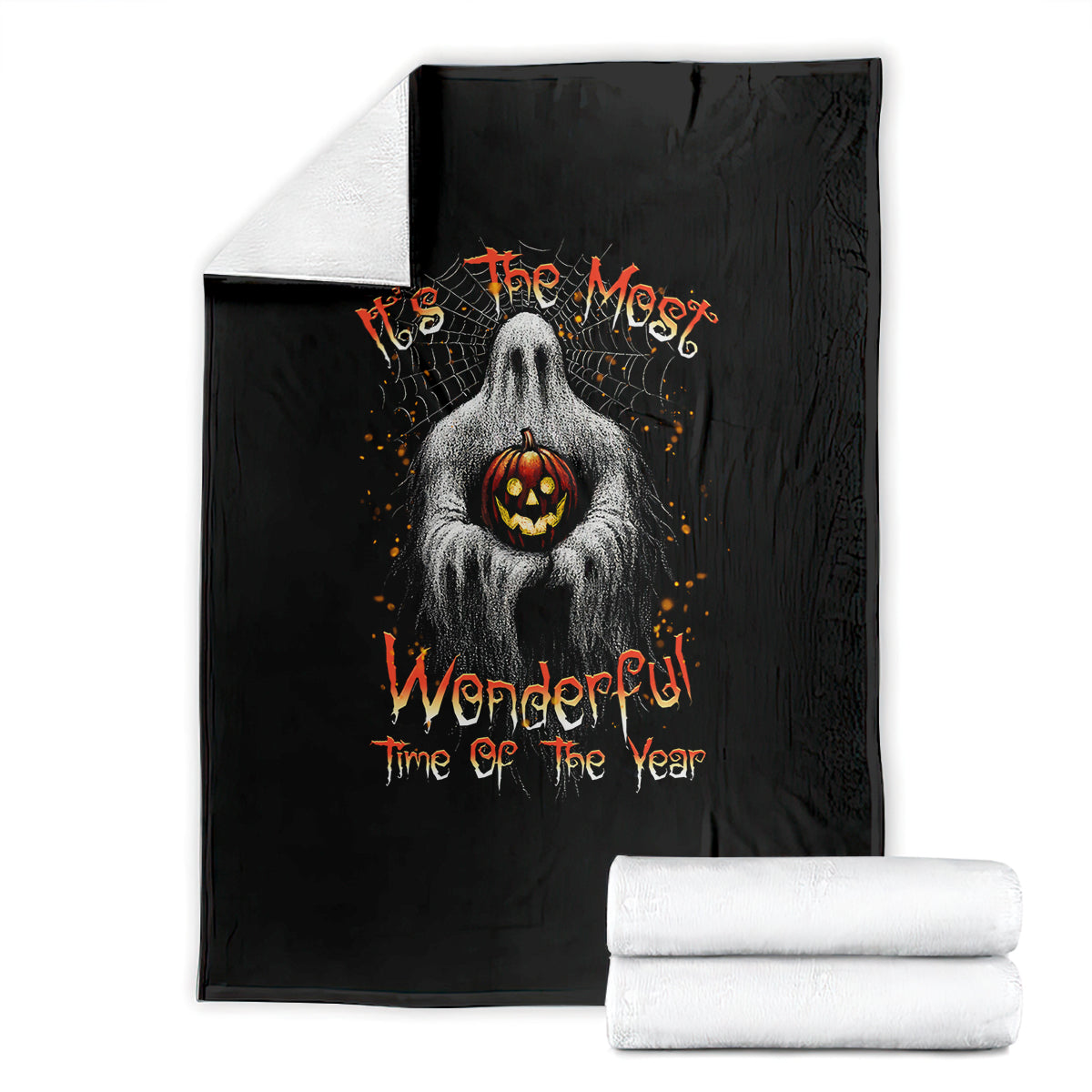 Black Halloween blanket folded with ghost holding jack-o-lantern and orange text
