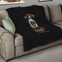 Black quilt on living room sofa, diamond quilting with ghost and jack-o-lantern design