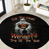Black round Halloween rug with gray ghost center, orange jack-o'-lantern, and script text