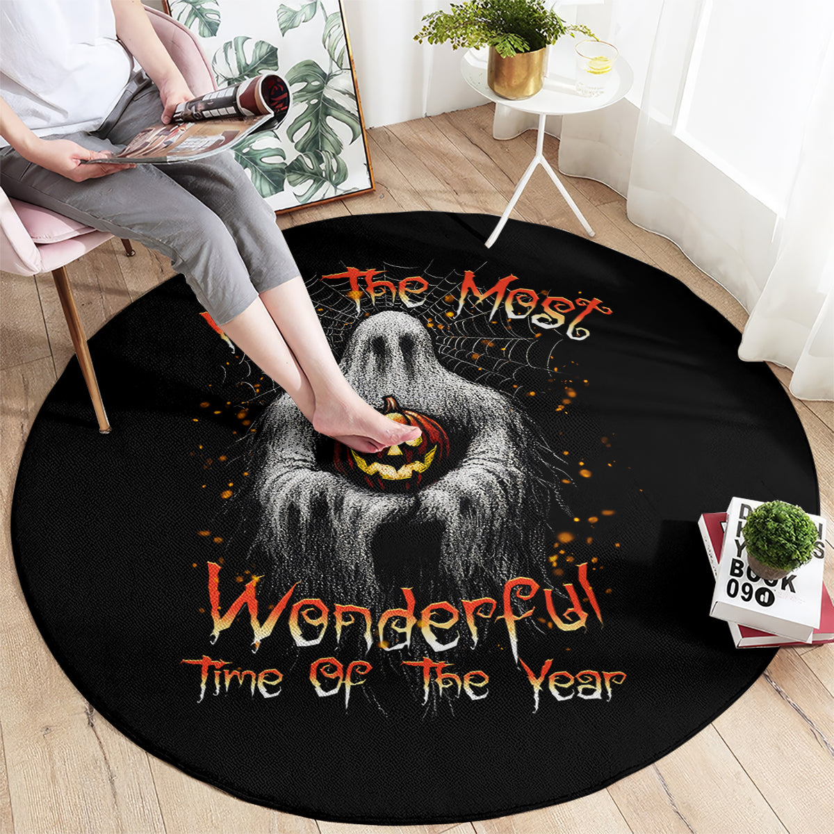 Black round Halloween rug with gray ghost, jack-o'-lantern face, and orange lettering