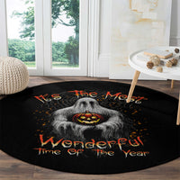 Black round Halloween rug with gray ghost graphic, orange jack-o'-lantern, and text