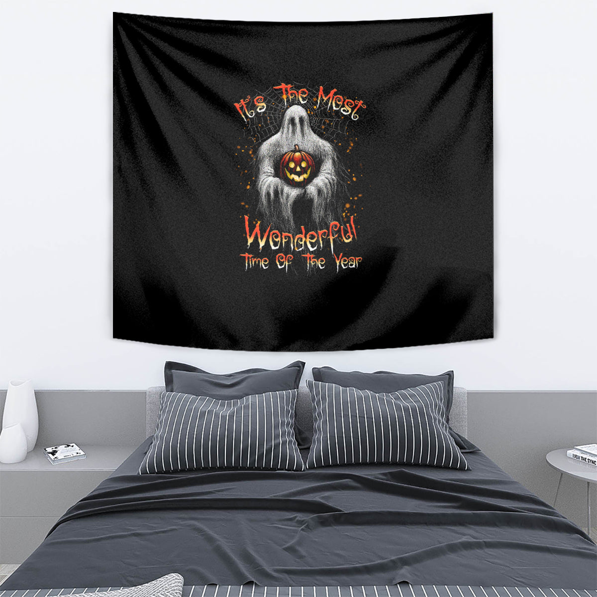 Black Halloween tapestry with ghost holding glowing jack-o'-lantern and orange lettering.