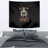 Black Halloween tapestry with ghost holding glowing jack-o'-lantern and orange lettering.
