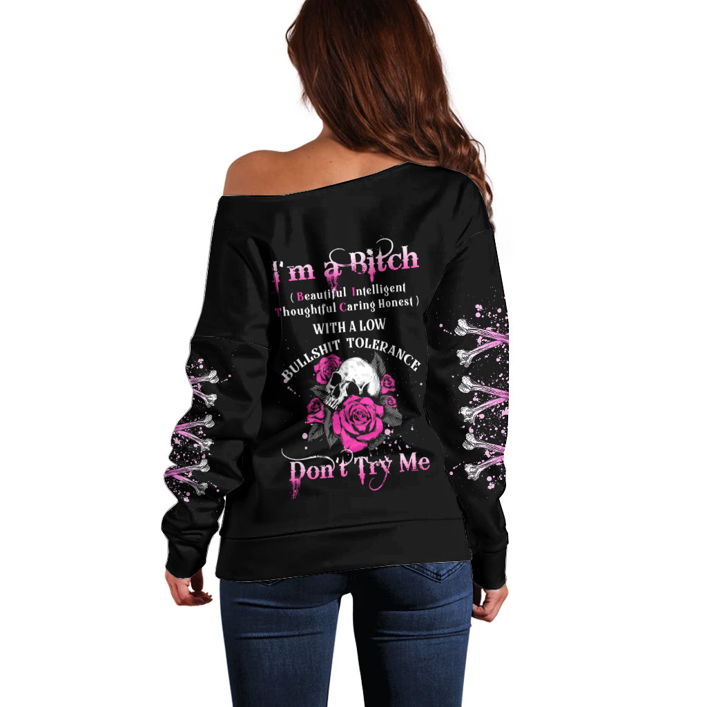 Black off-shoulder sweater with rose skull graphic on back, long sleeves