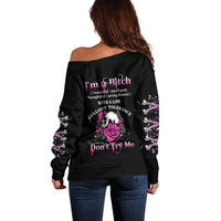 Black off-shoulder sweater with rose skull graphic on back, long sleeves