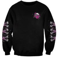 Black crewneck sweatshirt with small pink skull and rose graphic on chest.