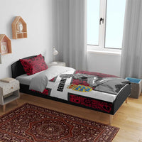 Red mermaid bedding set on bed with two matching patterned pillows and cross design