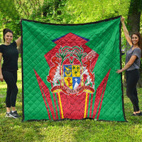 Green quilted blanket featuring a central red crest shield with ornate national emblem design.
