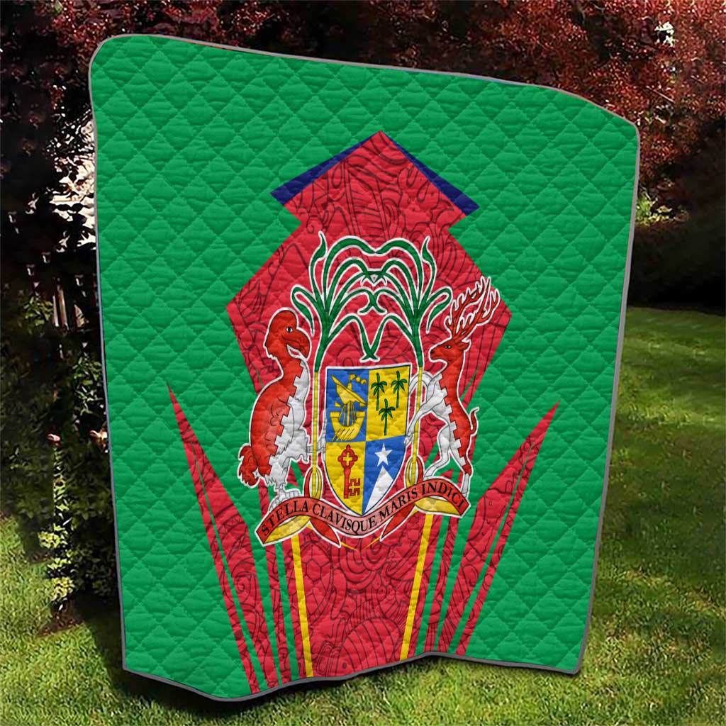 Green quilted throw blanket with central red-and-green coat of arms emblem and textured quilting.