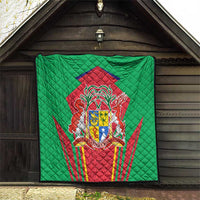 Green quilted blanket hanging display with central red crest and shield emblem, diamond stitching.