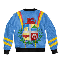 Blue bomber jacket back with shield crest, plants and ribbon stripes, ribbed hem