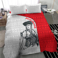 Close view of red and white folk pattern duvet cover with warrior graphic and pillows