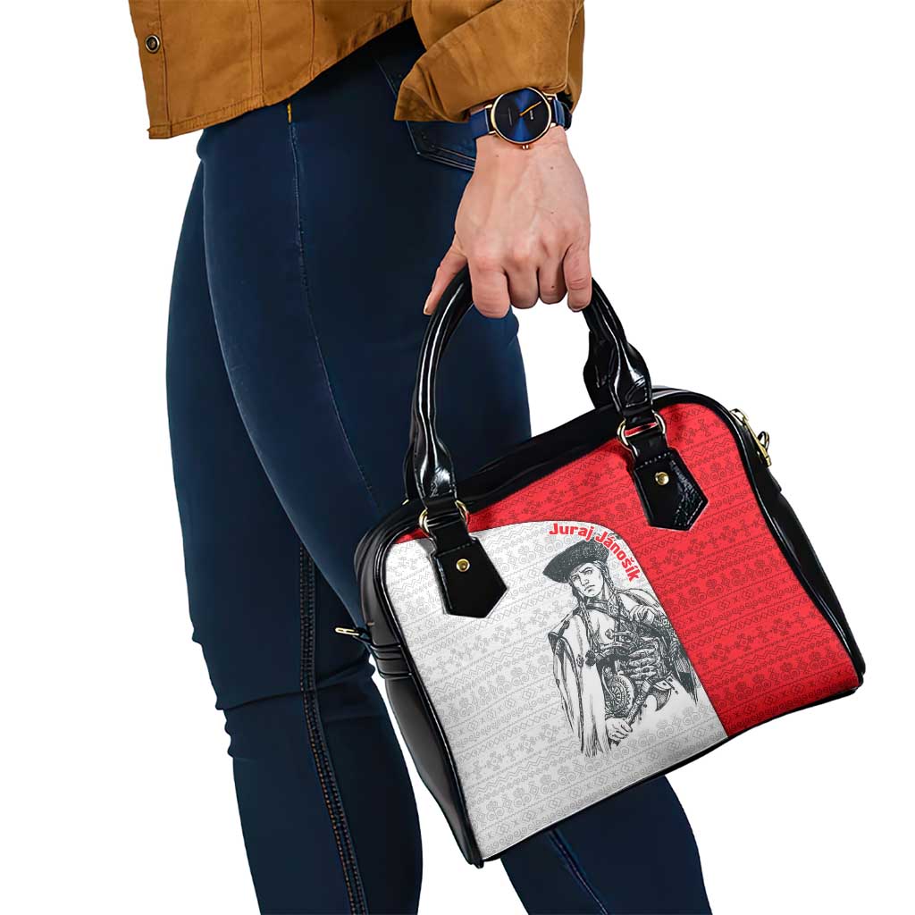 Shoulder handbag angled view with red panel, white print, black strap and handles