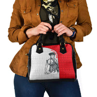Shoulder handbag front view with red-and-white graphic panel and black zipper top