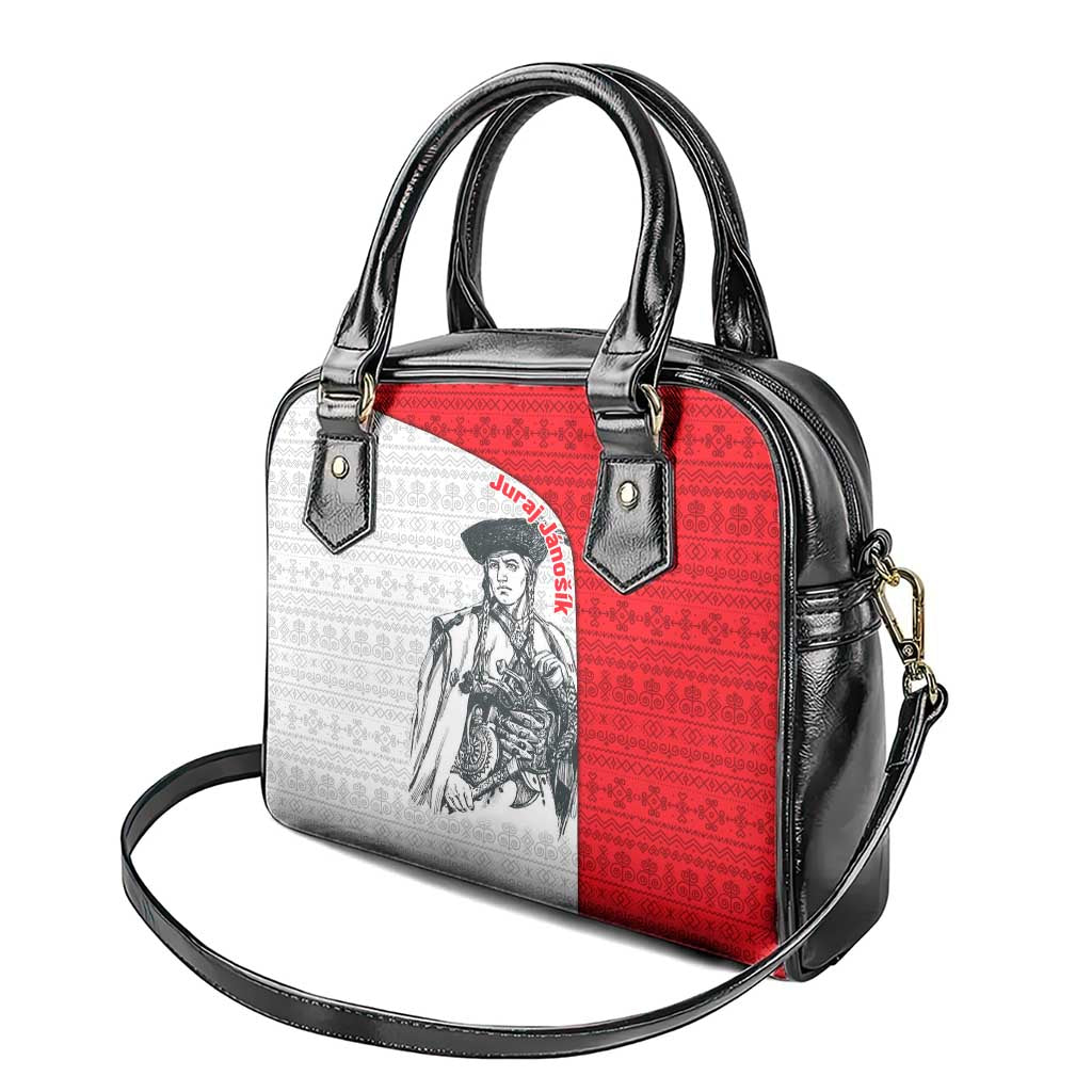 Handbag with two black handles, red-and-white panel, and crossbody strap attached