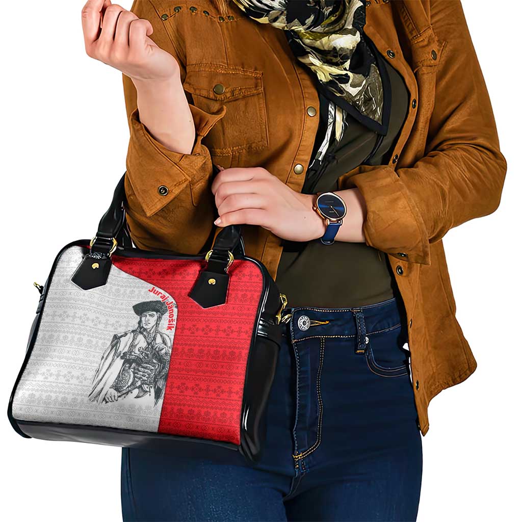 Shoulder handbag with red-and-white folk print panel, black handles, and side strap