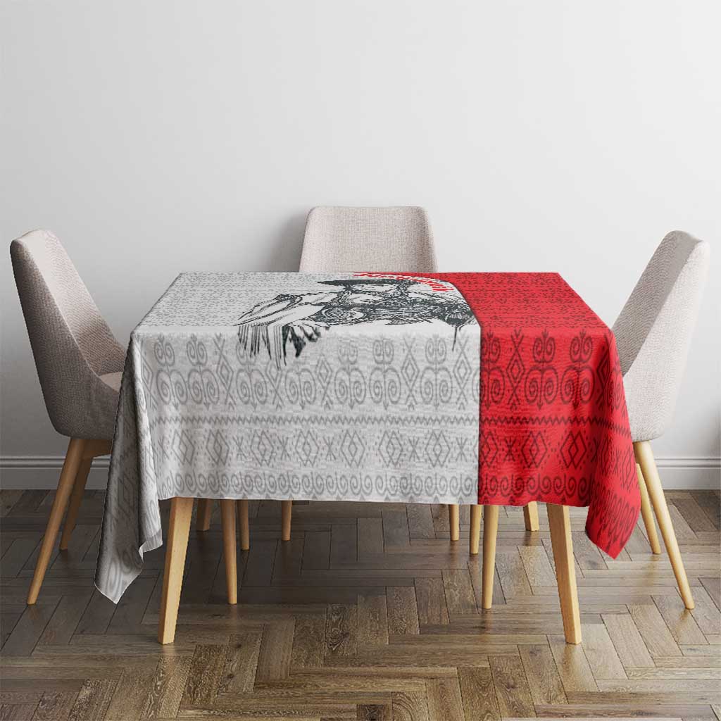 Red-and-white folk-pattern tablecloth on a dining table with four chairs