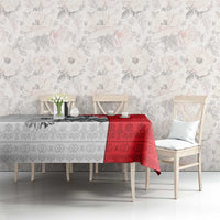 Red and white folk-pattern tablecloth draped across a dining table in a room